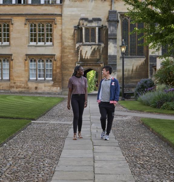 Two students walking and chatting in college 