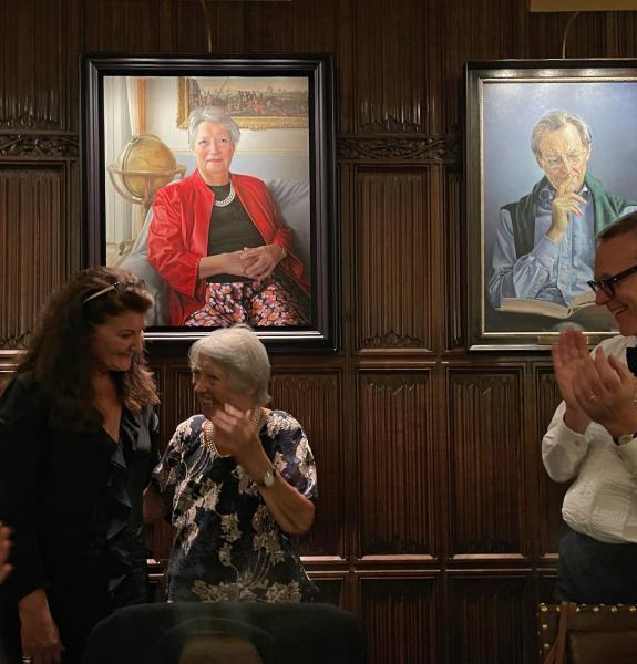 Three people in front the a portrait