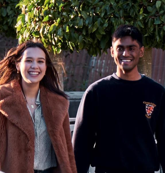 Two students walking in New Court