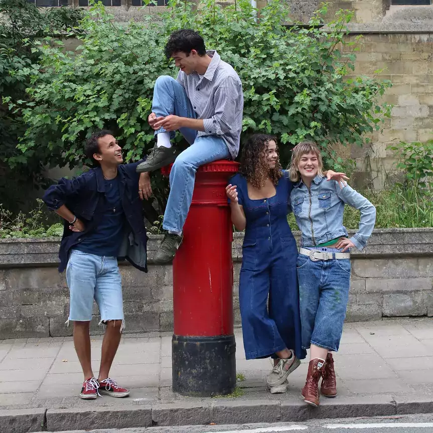 four people around a post box