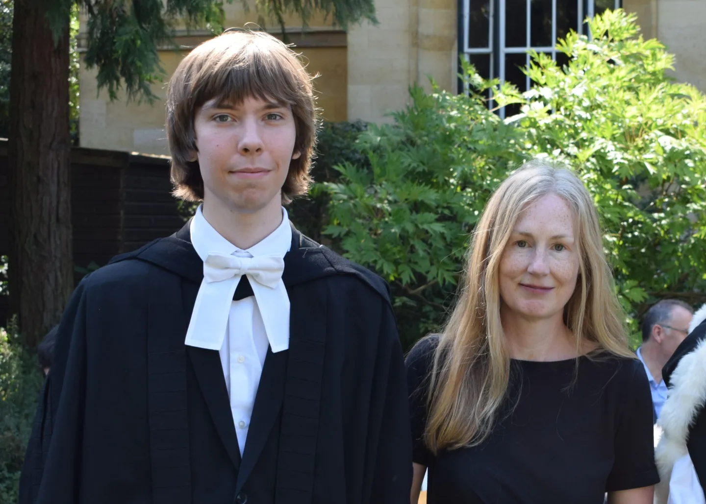 Headshots of Ihor and Emily Tomlinson at graduation