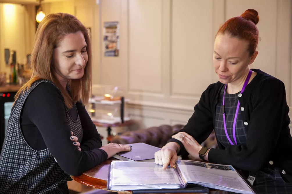 Two people looking at a document